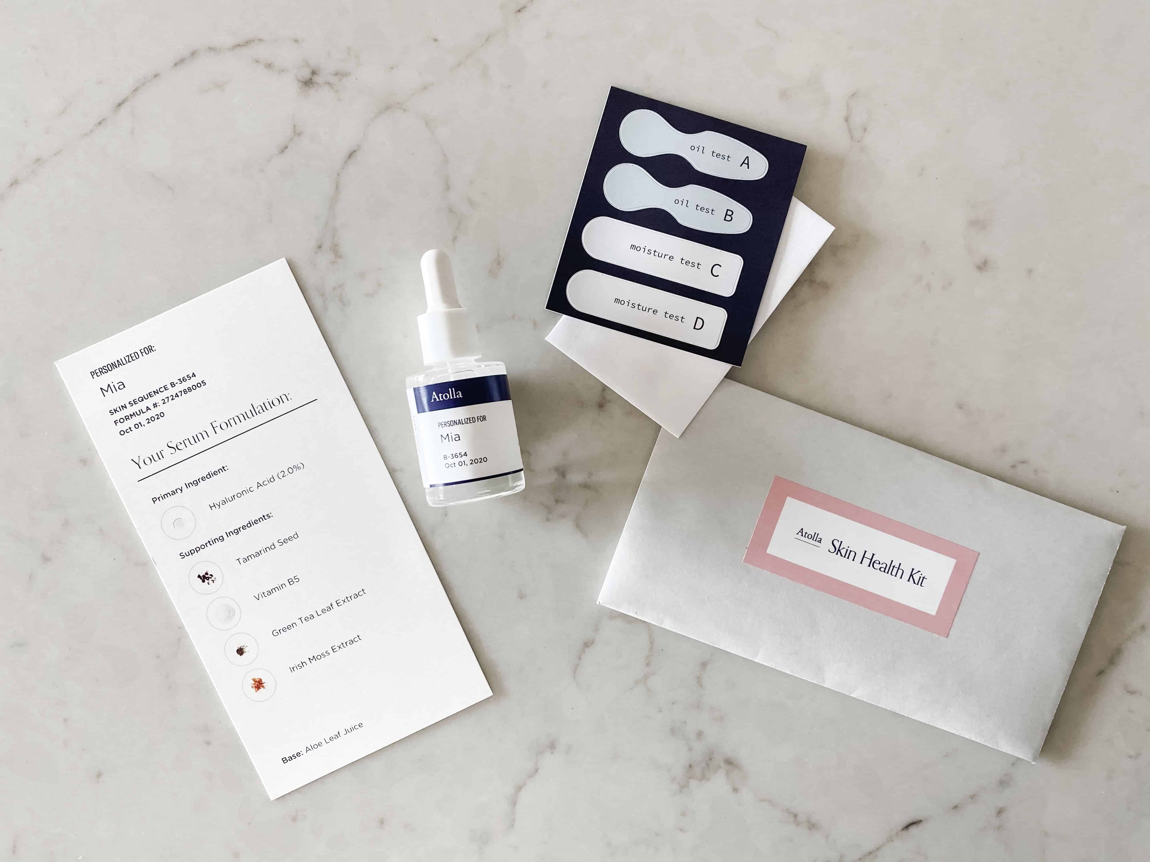 Contents of Atolla Skincare Kit complete with a custom serum, serum formulation, and a skin health kit