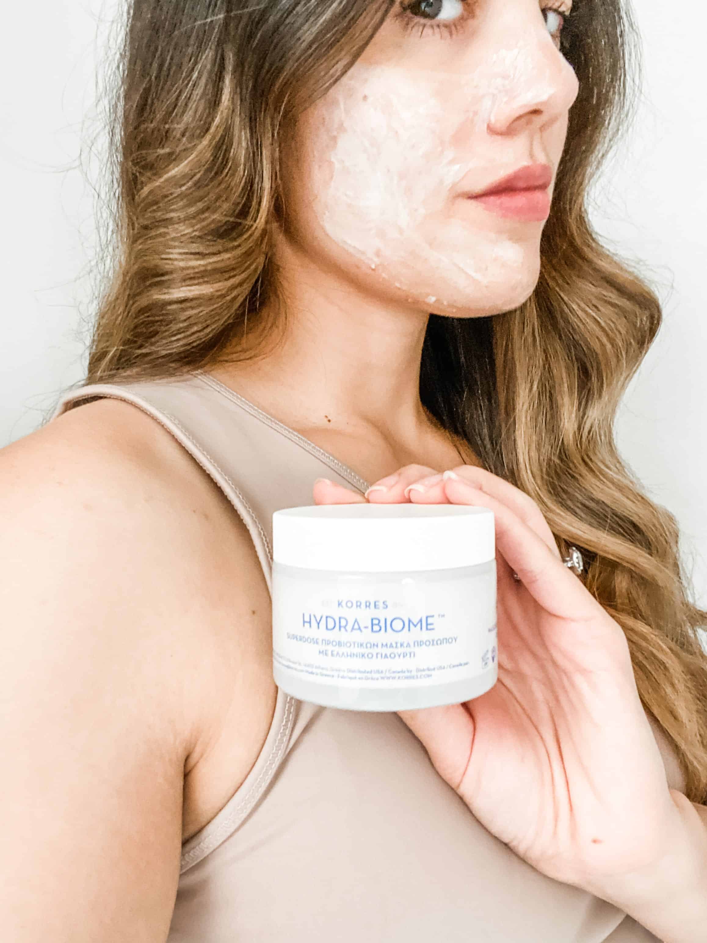 picture of woman with face mask applying probiotic acne skincare